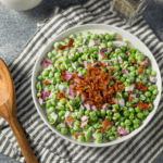 overhead image of pea salad on a striped napkin