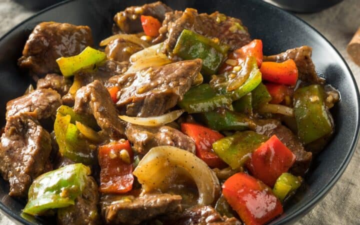Pepper Steak in a stone colored bowl with a bowl of rice next to it - 4