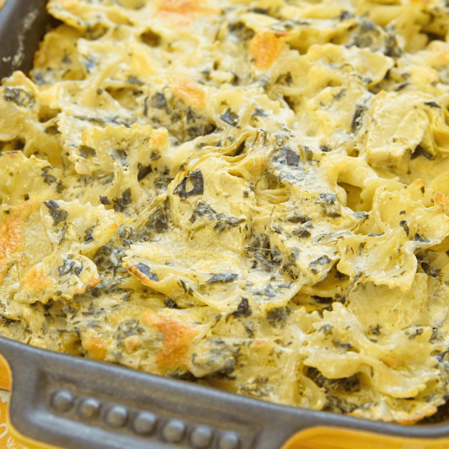Close up image of Spinach Artichoke Pasta in a baking dish 