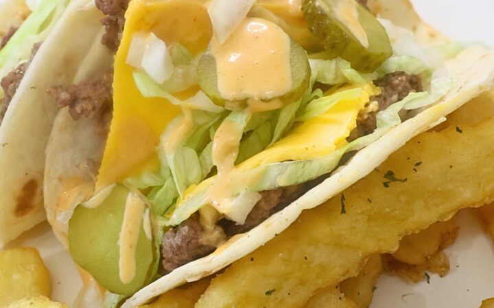 Two Tortilla Burgers with french fries on a plate