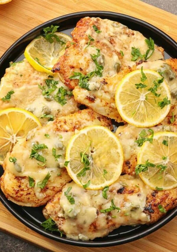Overhaed image of Chicken Piccata on a black plate
