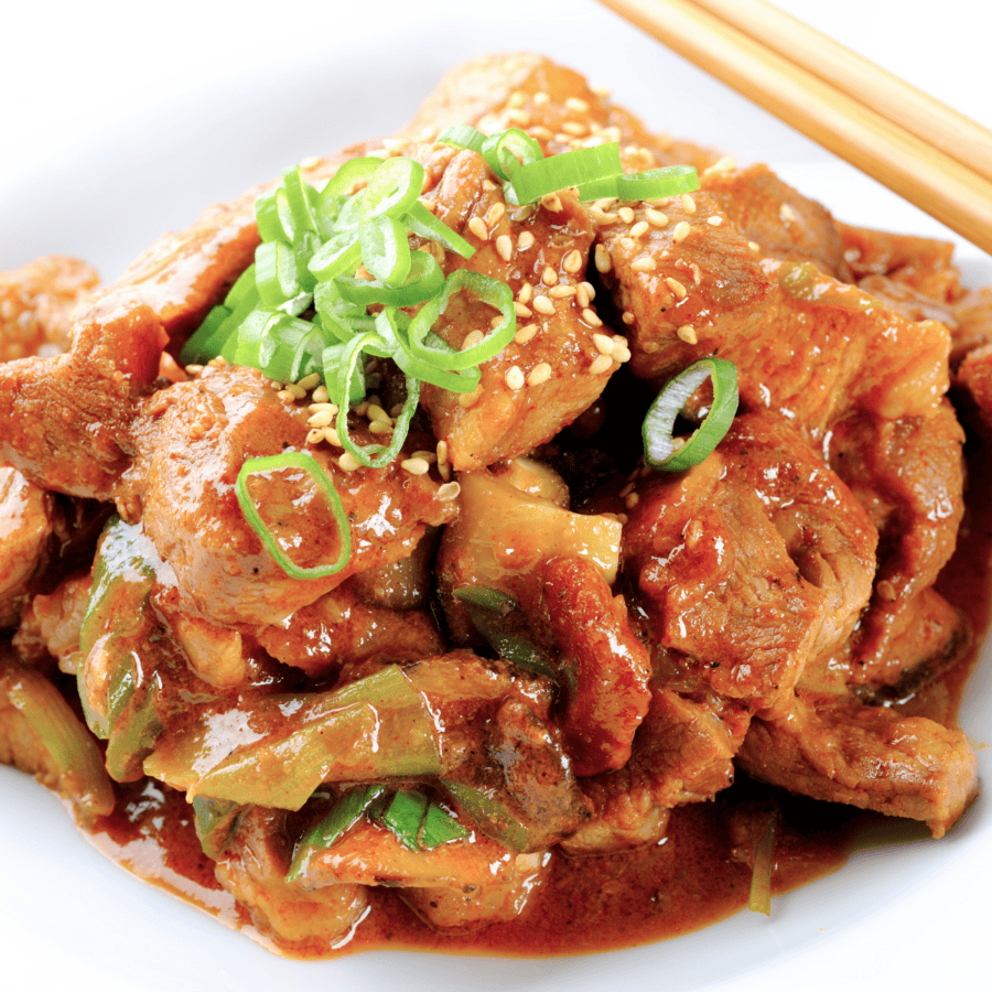 Chicken Bulgogi in a white serving bowl with chopsticks