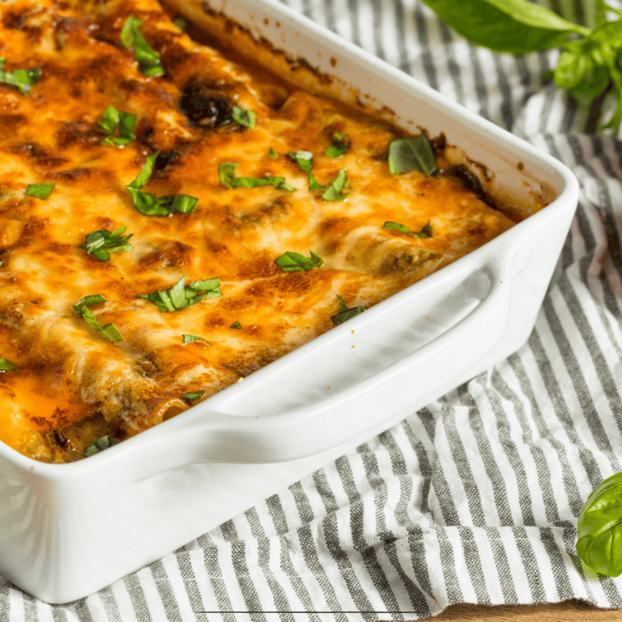 Close up image of Chicken Lasagna in a white baking dish