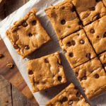 Chocolate Chip Cookie Bars resting on parchment paper - 8