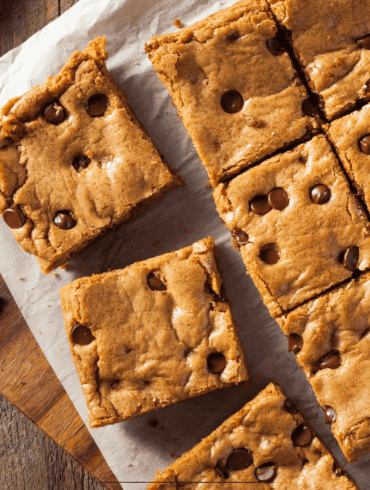Chocolate Chip Cookie Bars resting on parchment paper