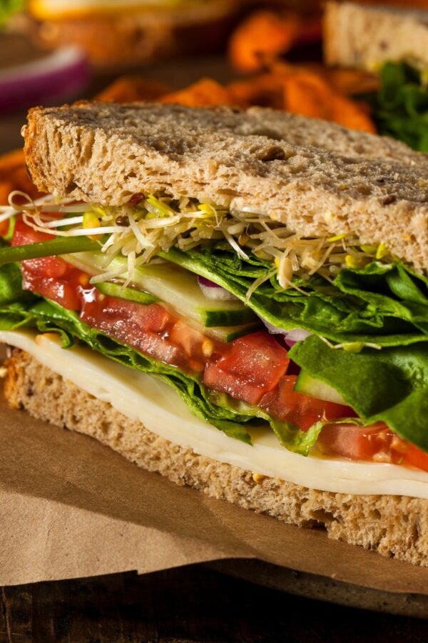 Close up image of hummus sandwich with veggies