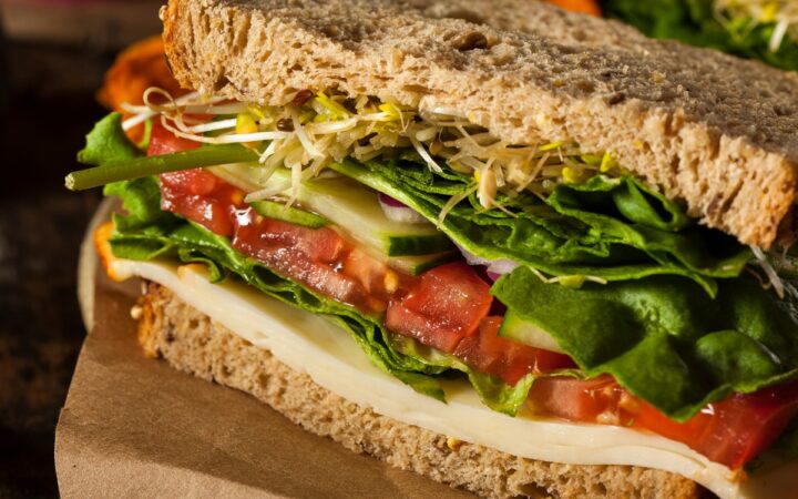 Close up image of hummus sandwich with veggies