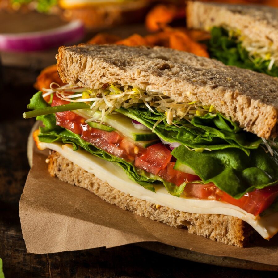 Close up image of hummus sandwich with veggies