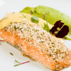 Close up image of Parmesan Crusted Salmon with vibrant garnish