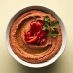 Overhead image of Roasted Red Pepper Hummus in a white round bowl - 8