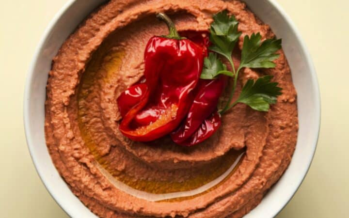 Overhead image of Roasted Red Pepper Hummus in a white round bowl