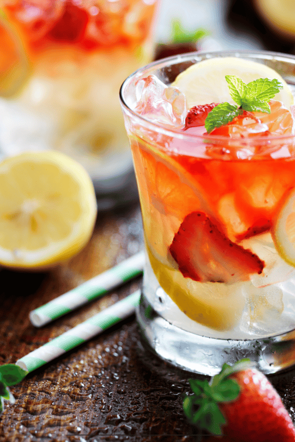 Strawberry lemonade in a glass with strawberry and lemon garnish