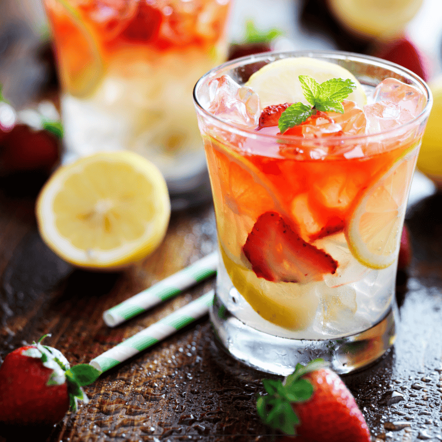 Strawberry lemonade in a glass with strawberry and lemon garnish