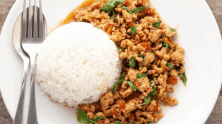 Overhead image of Thai Basil Chicken on a white plate with rice