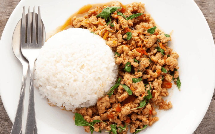 Overhead image of Thai Basil Chicken on a white plate with rice