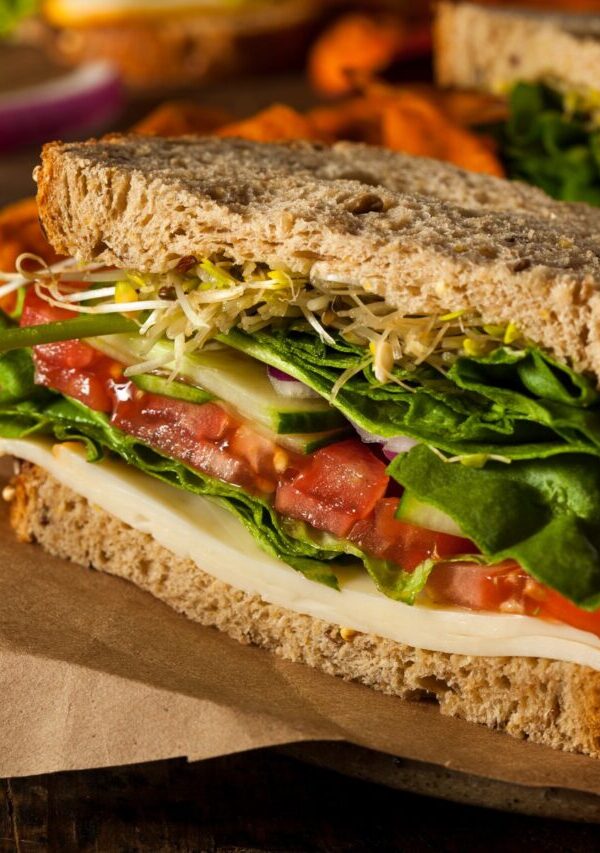 Close up image of hummus sandwich with veggies