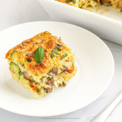 A piece of Breakfast Croissant Casserole on a white plate