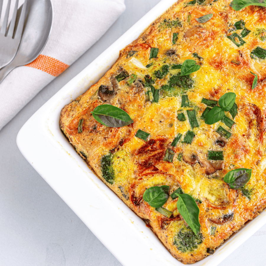 Overhead image of Breakfast Croissant Casserole in a white baking dish