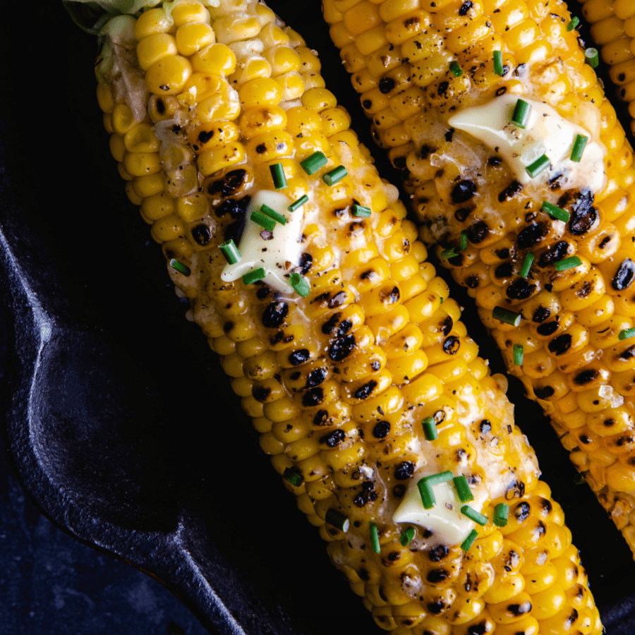 Overhead image of Cajun Corn on the Cob in a cast iron skillet