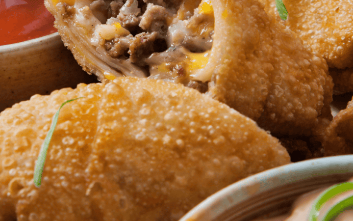 Close up image of a cheeseburger egg roll cut in half