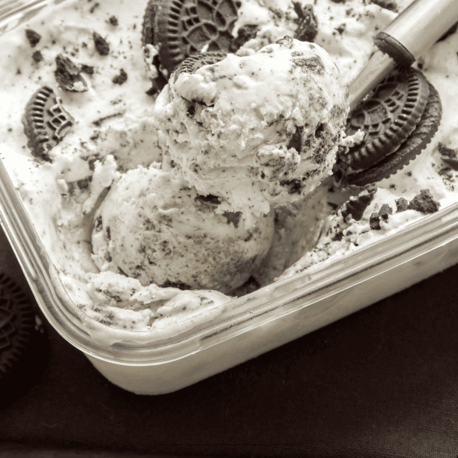 close up image of cookies and cream ice cream in a glass dish