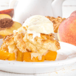 Close up image of crock pot peach cobbler with a scoop of vanilla ice cream - 8