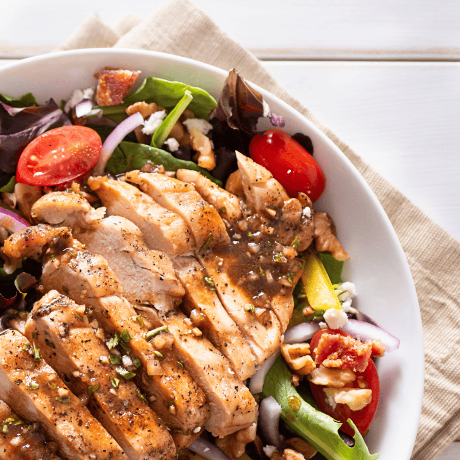 Close up image of Honey Balsamic Chicken on a bed of salad