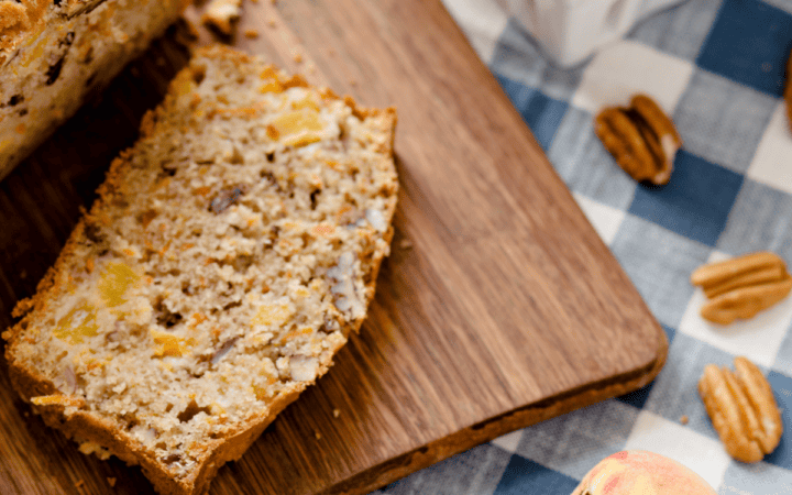 Close up image of Peach Bread on a wooden cutting board