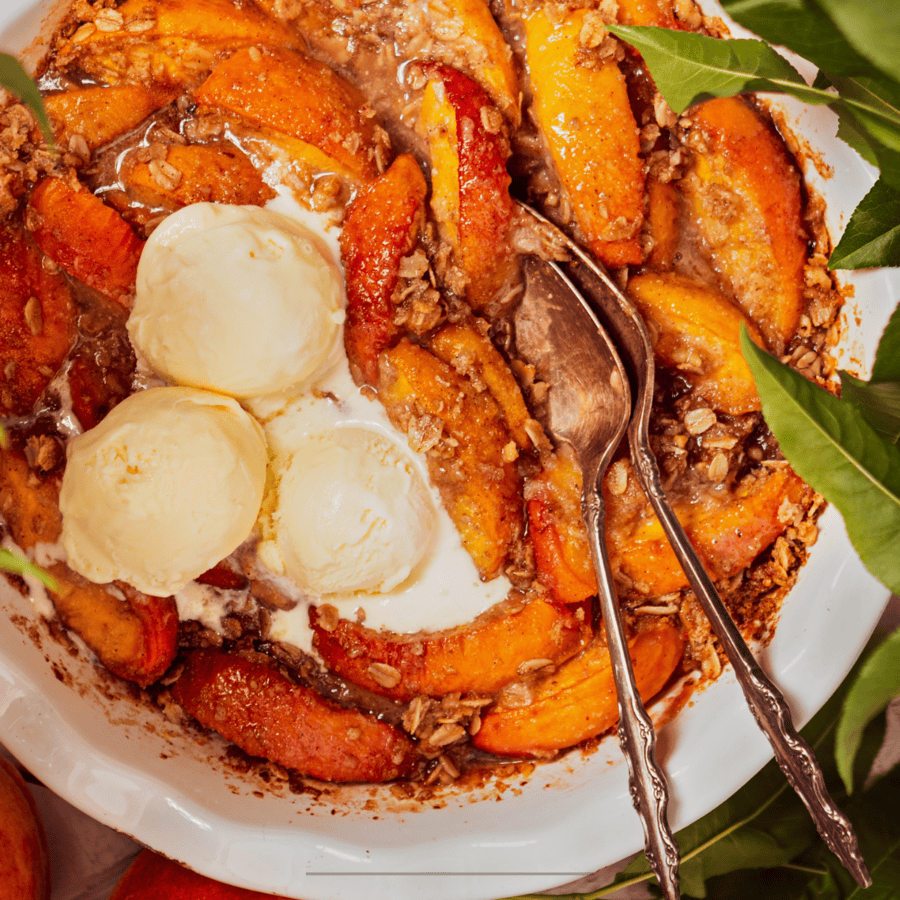 Overhead image of Peach Crisp with scoops of vanilla ice cream