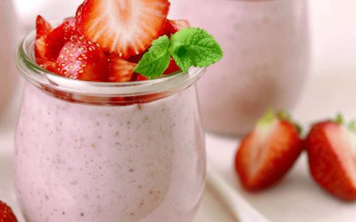 Two jars of Strawberry Mousse with fresh strawberry garnish