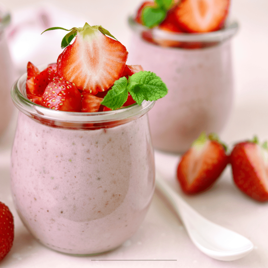 Two jars of Strawberry Mousse with fresh strawberry garnish