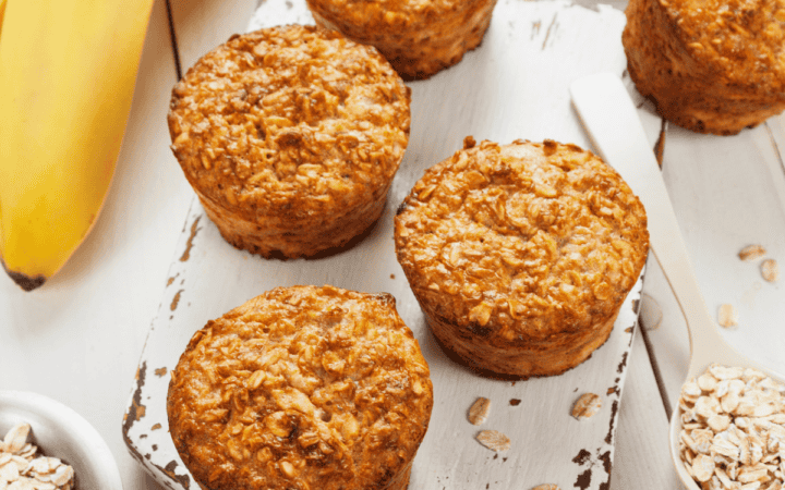 Banana Oatmeal Muffins on a white wooden cutting board