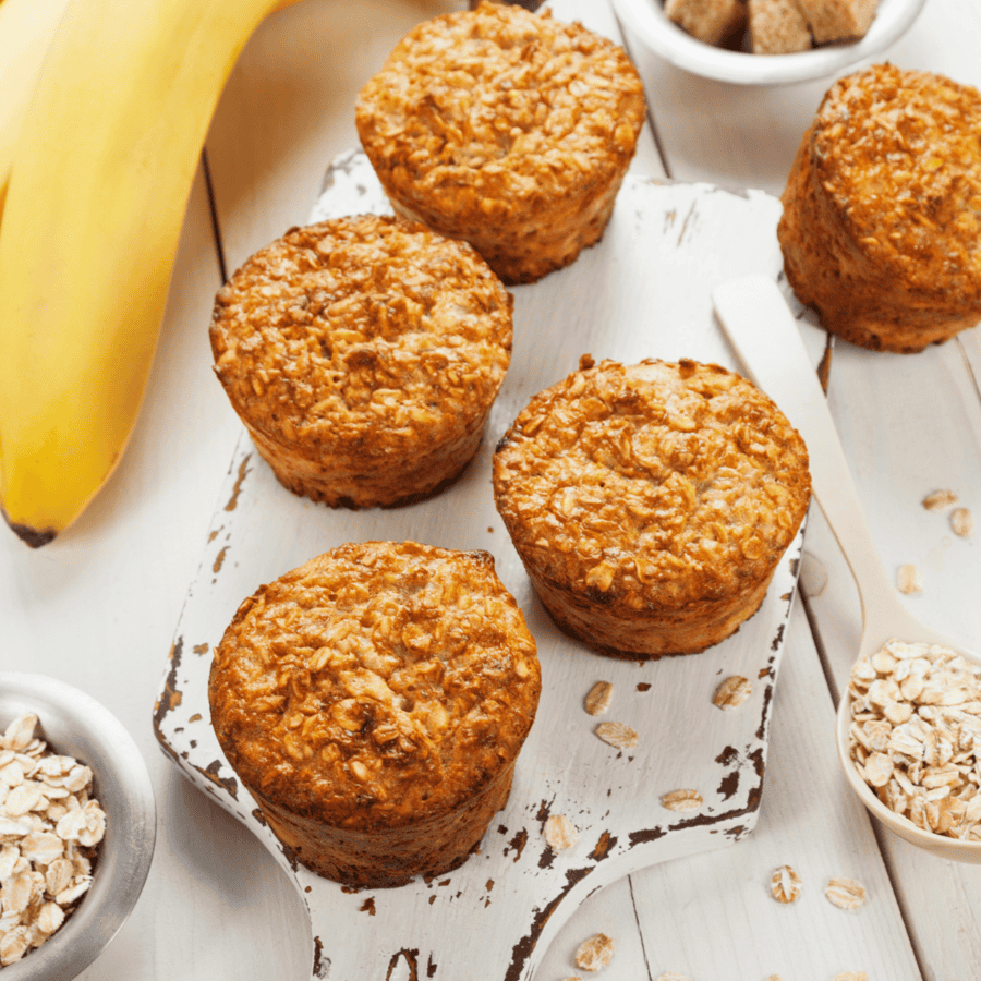 Banana Oatmeal Muffins on a white wooden cutting board