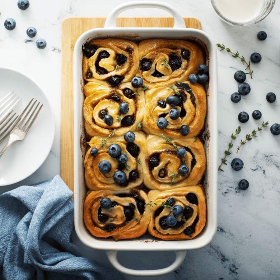 Overhead image of blueberry cinnamon rolls in a baking dish