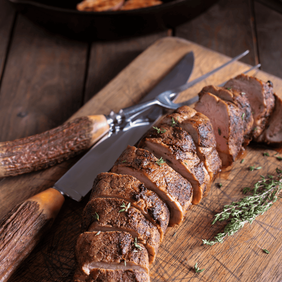 Sliced Grilled Pork Tenderloin on a wooden cutting board