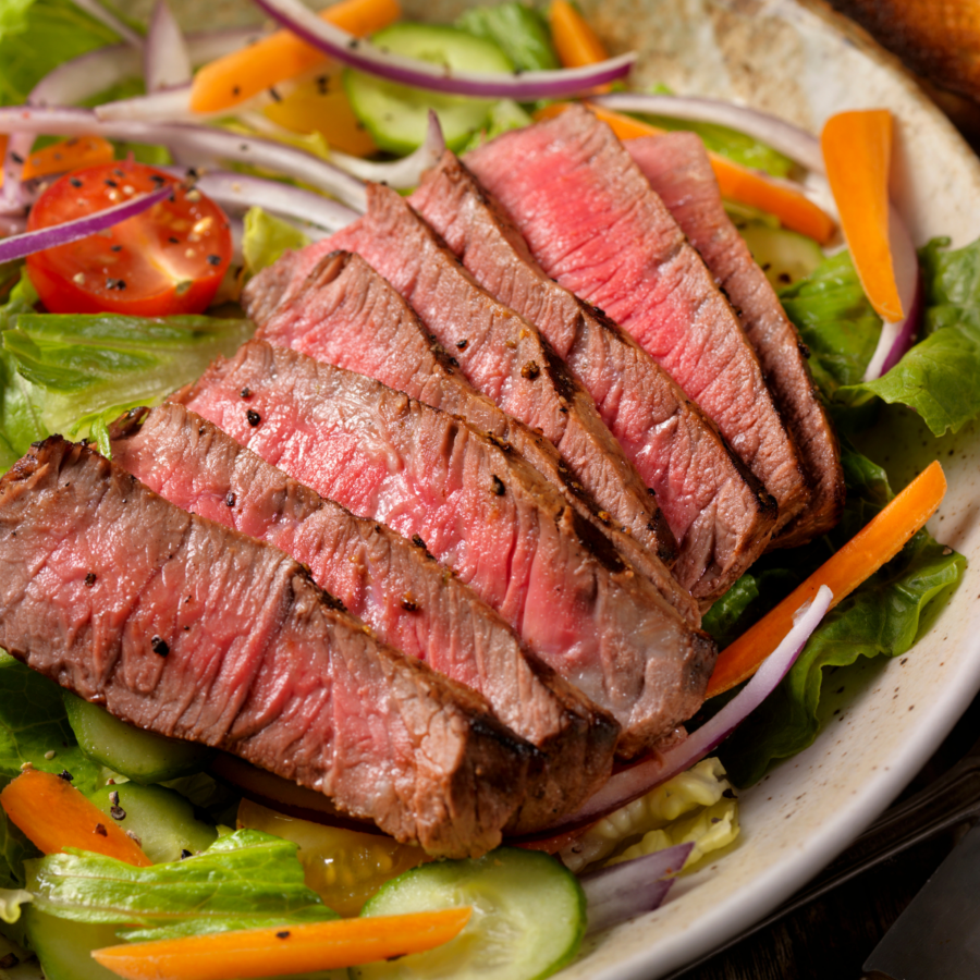 Overhead image of steak salad in a white bowl