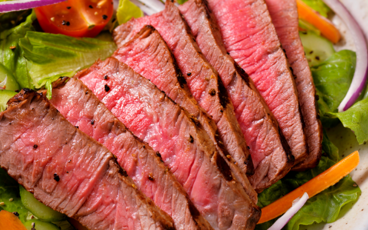 Overhead image of steak salad in a white bowl