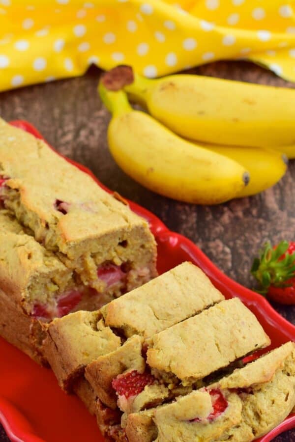 Strawberry Banana Bread sliced on a red platter