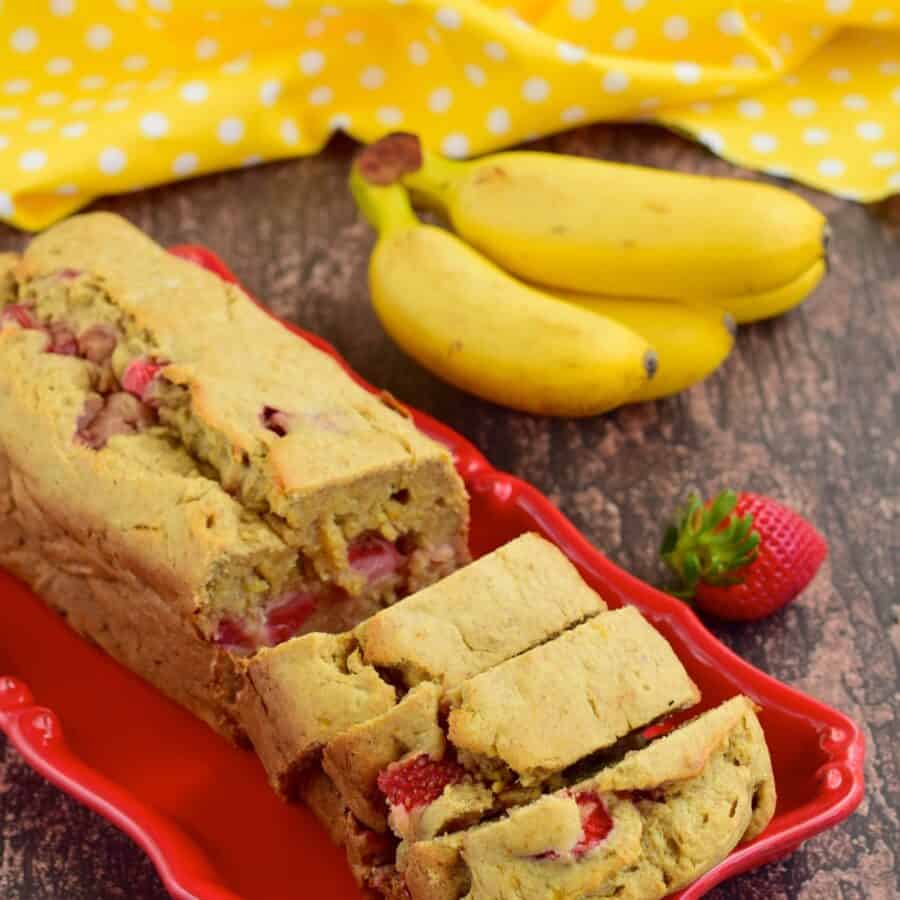 Strawberry Banana Bread sliced on a red platter