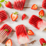 Overhead image of strawberry popsicles with sliced strawberries next to them - 8