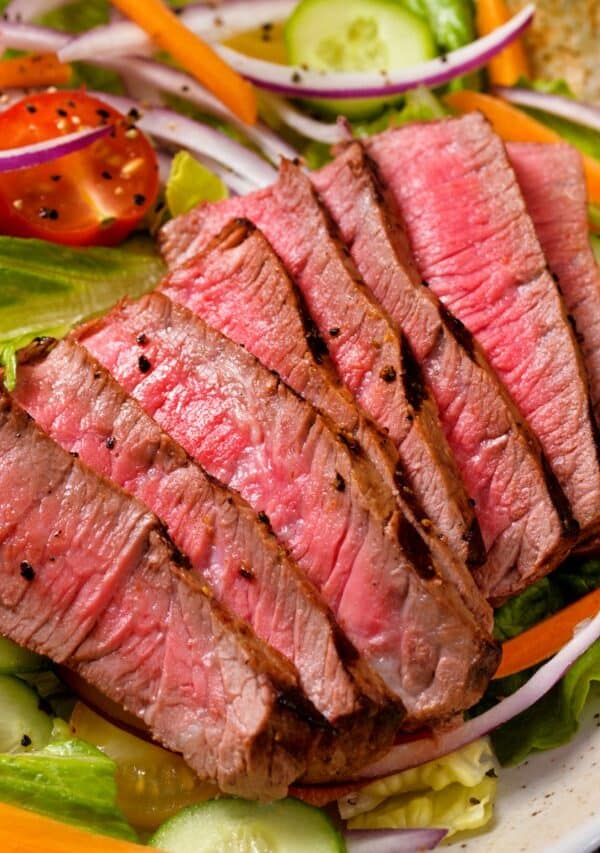 Overhead image of steak salad in a white bowl