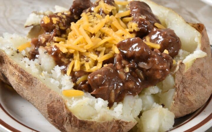 Beef Tips in Gravy on top of a baked potato