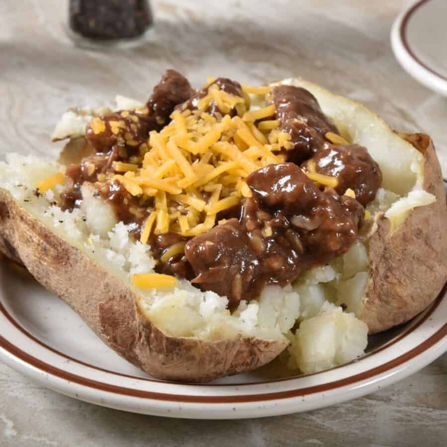 Beef Tips in Gravy on top of a baked potato