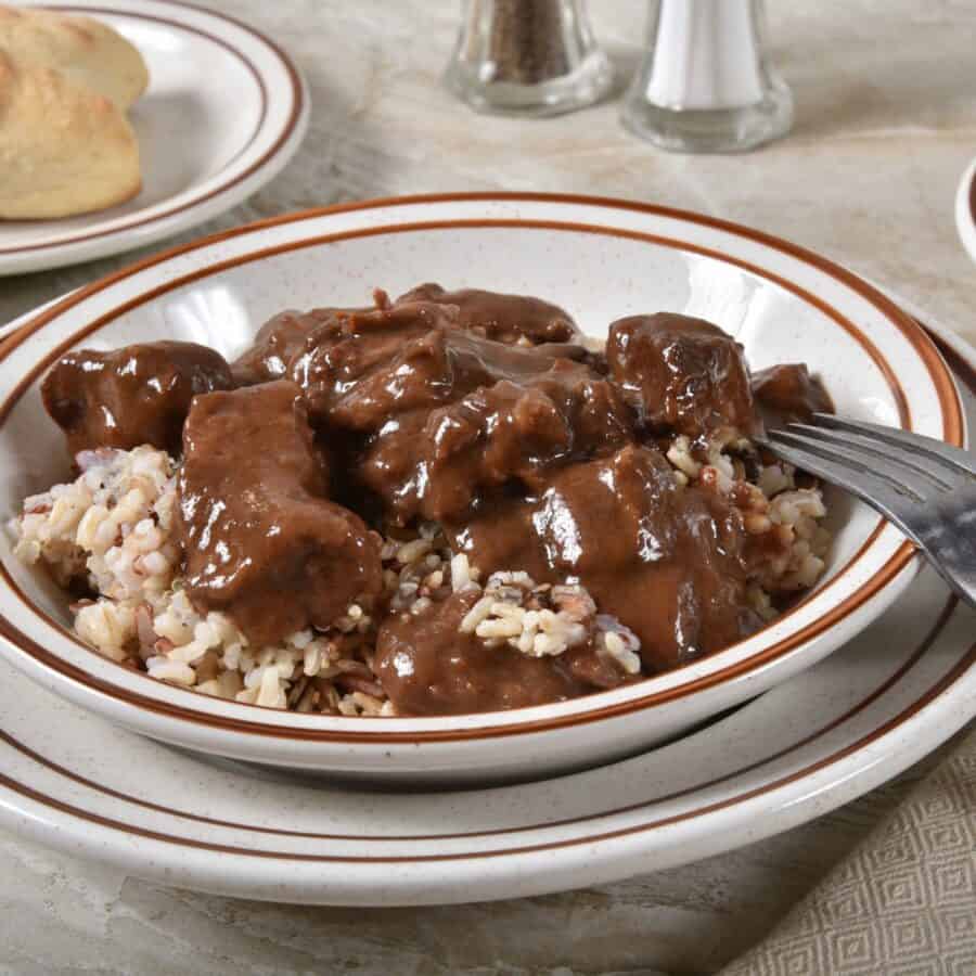 Beef Tips in Gravy on top of a bowl of white rice