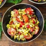 Overhead image of Corn and Tomato Salad in a black bowl - 8