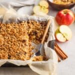 Healthy Apple Crisp in a baking dish with a serving spoon in it