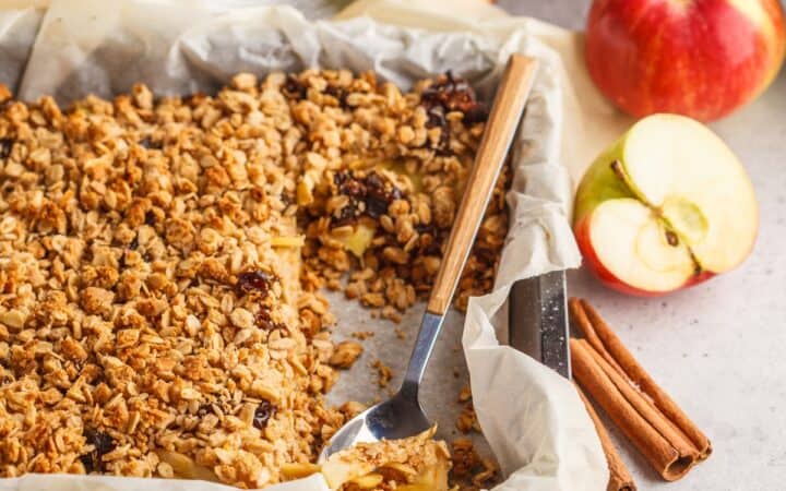 Healthy Apple Crisp in a baking dish with a serving spoon in it