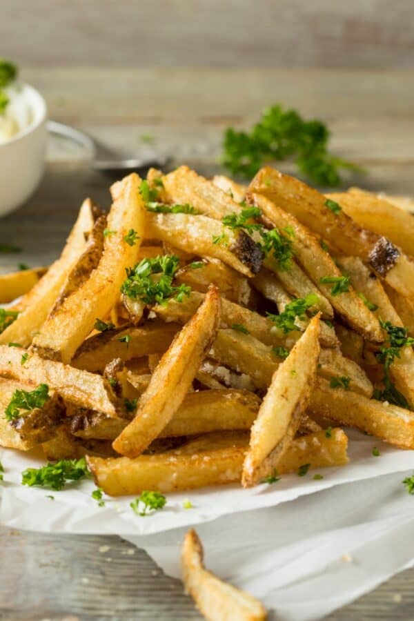 Homemade French Fries on a platter with a ramekin of dipping sauce