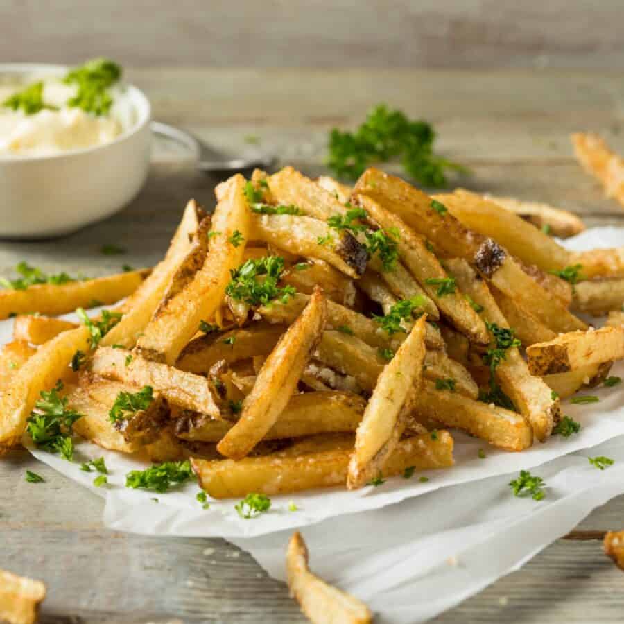 Homemade French Fries on a platter with a ramekin of dipping sauce