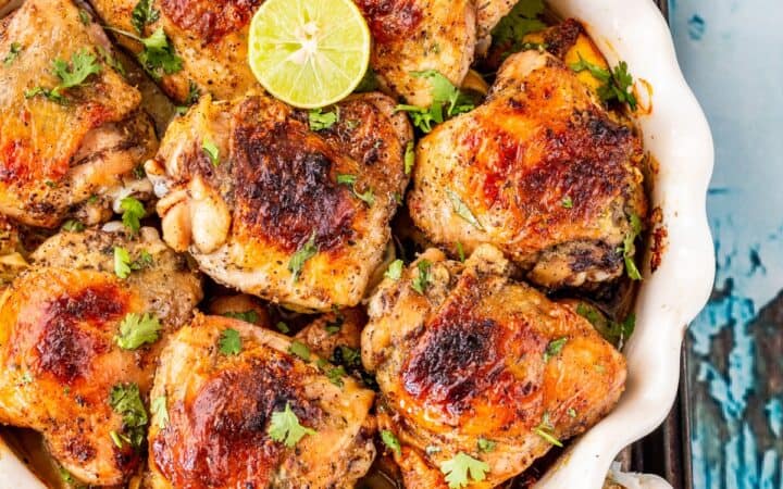 Overhead image of Baked Honey Lime Chicken thighs in a white baking dish